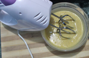 Whisking the batter with electronic hand mixer 